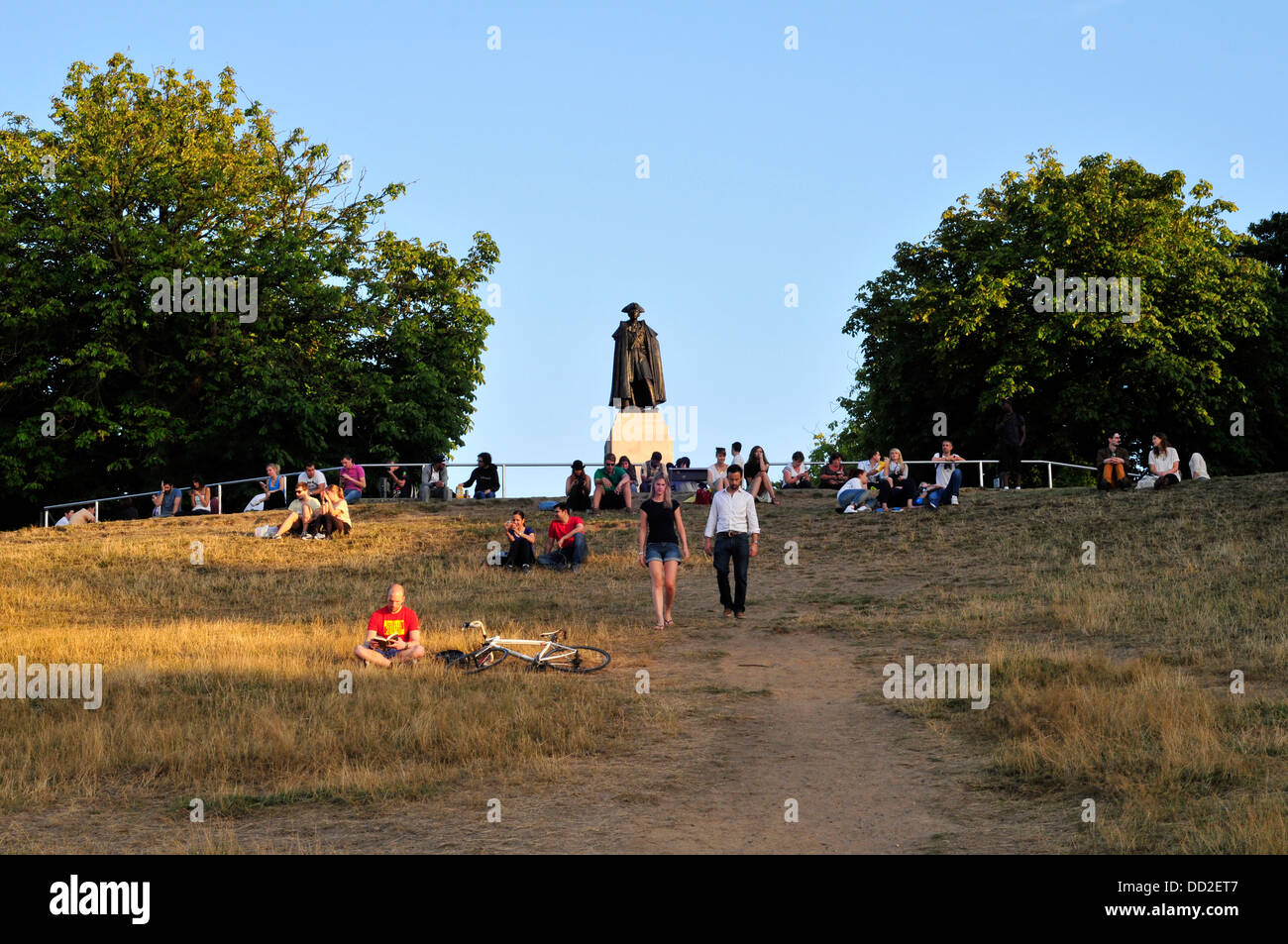 People sitting on top of the hill, Greenwich Park, London, UK Stock Photo