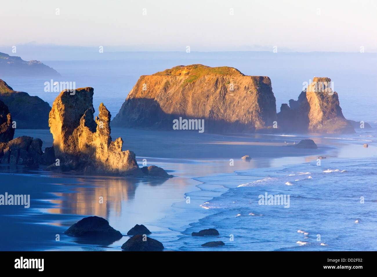 Morning Light Adds Beauty To Fog Covered Rock Formations At Bandon State Park; Bandon, Oregon, United States of America Stock Photo