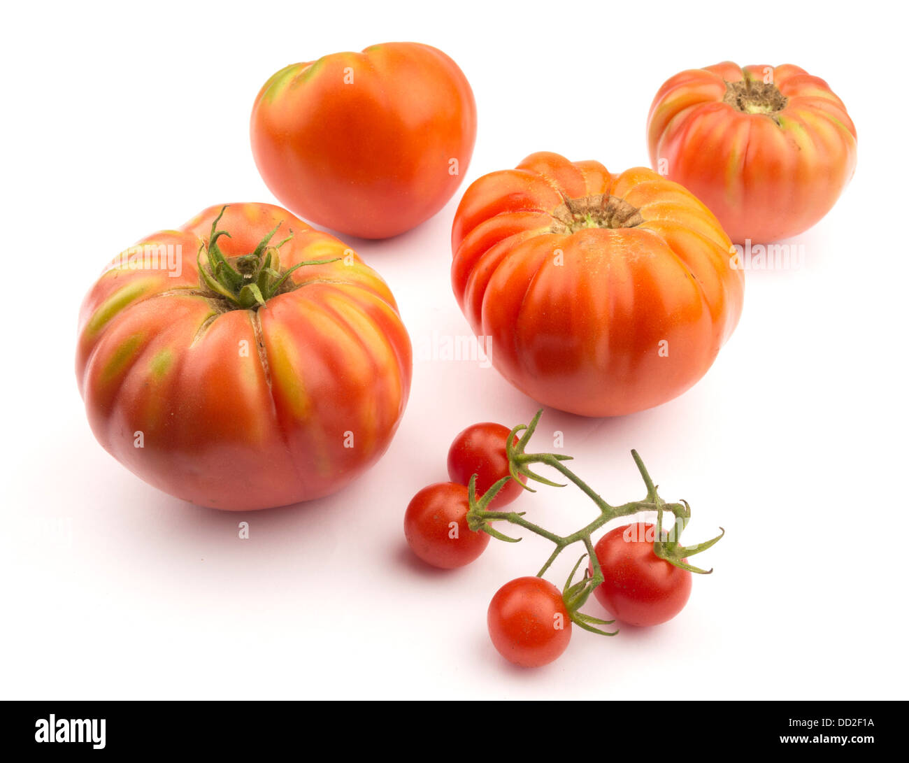 Fresh heirloom tomatoes cut out isolated on white background Stock Photo