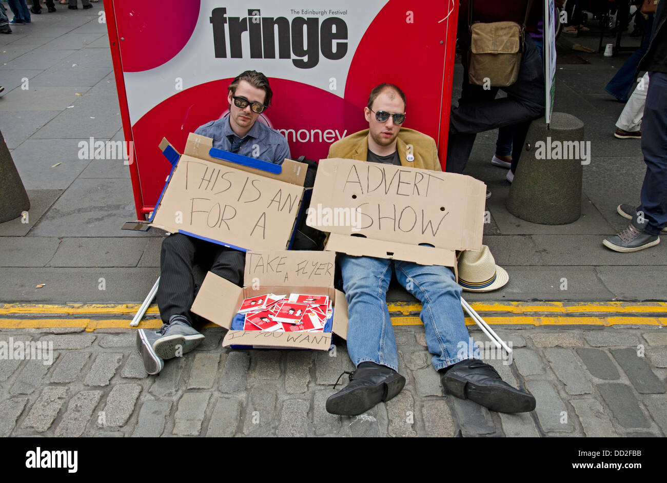 Two lazy performers promoting their show on the Edinburgh Fringe with the minimum of effort. Stock Photo