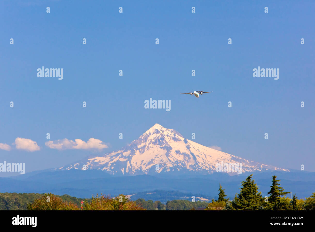 A Jet Takes Off From Portland International Airport With Mount Hood In The Background; Portland, Oregon Stock Photo
