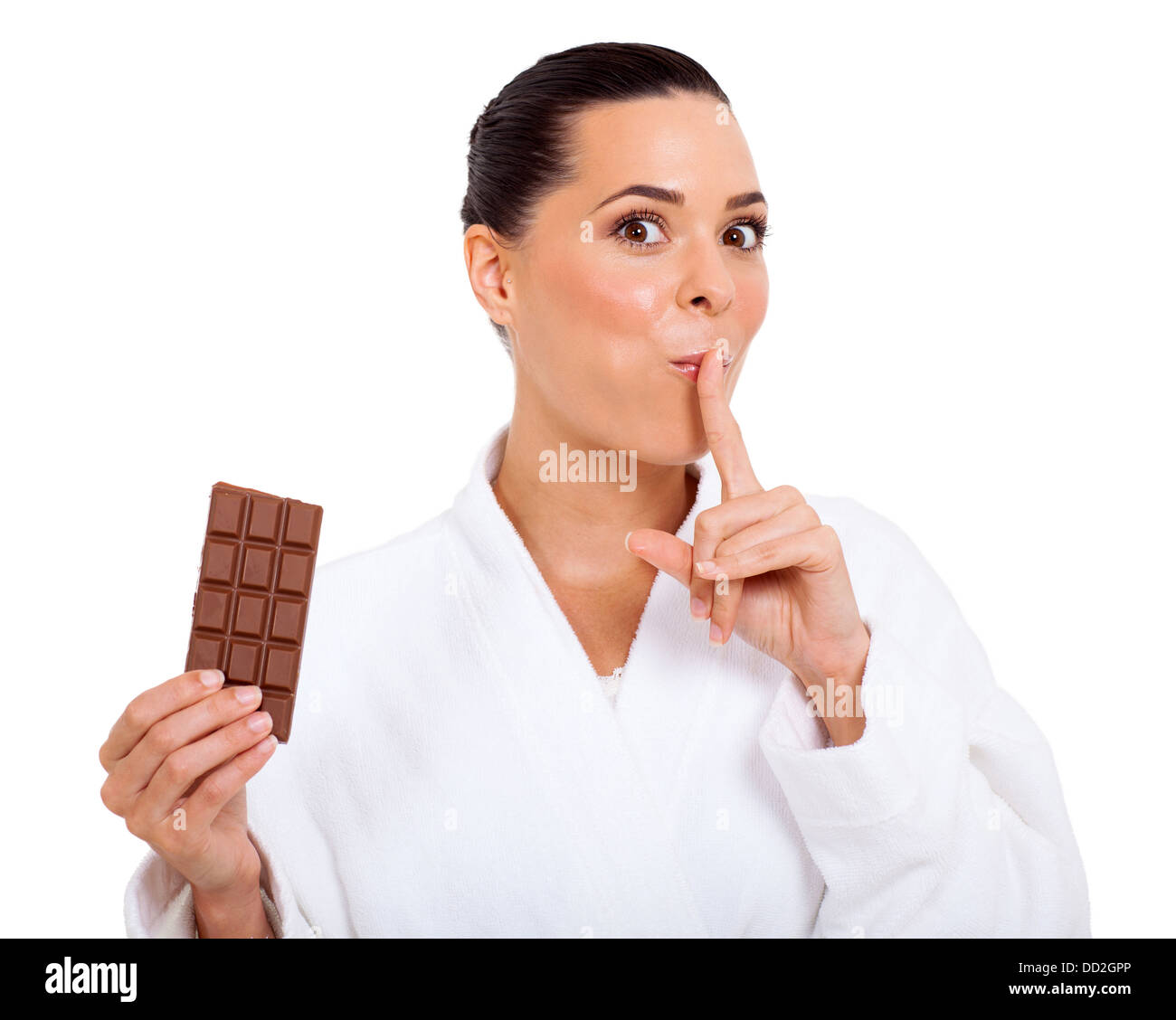 cute woman breaking a diet by eating chocolate and giving shhh sign Stock Photo