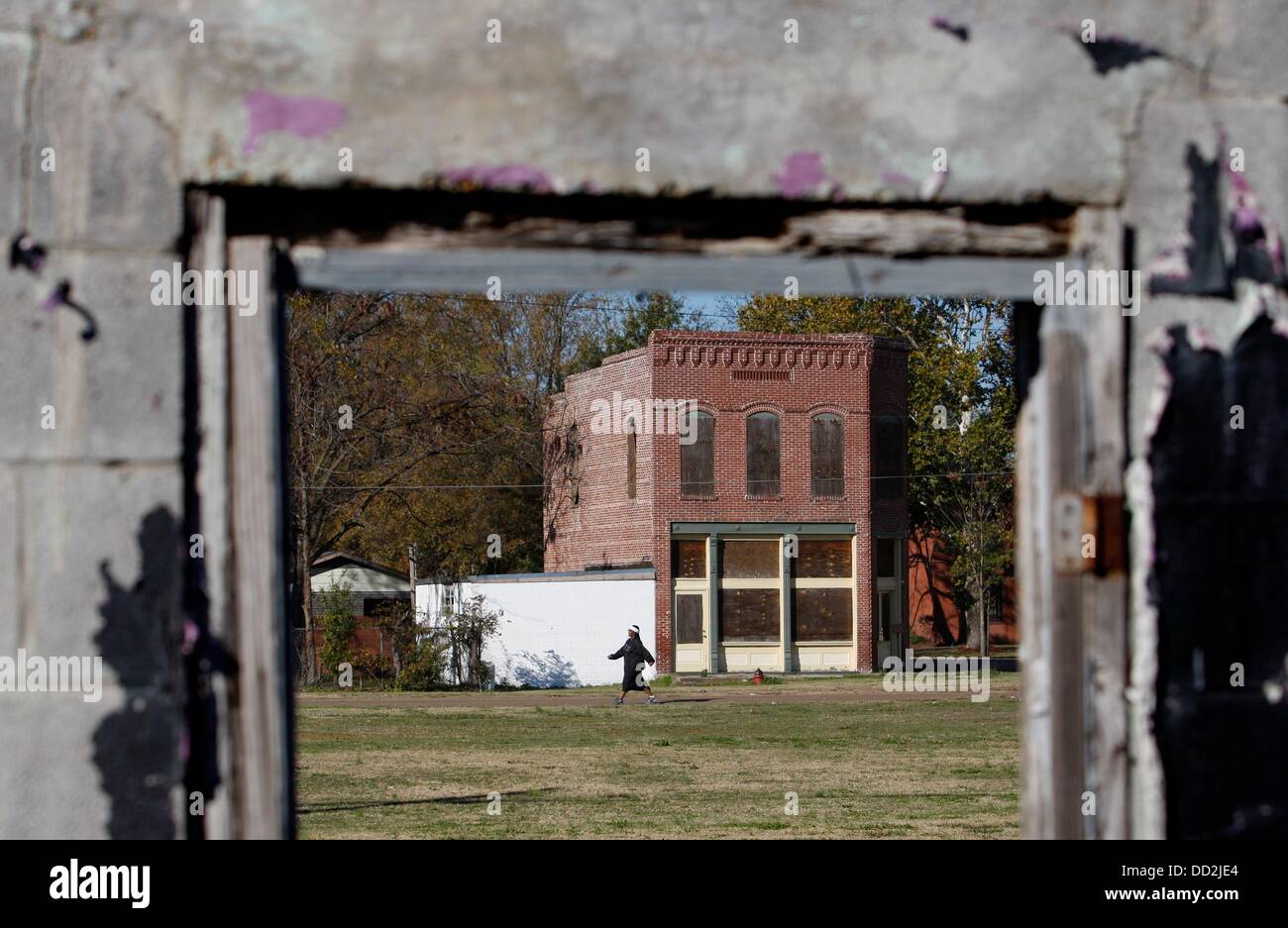 Nov. 17, 2012 - Mound Bayou, MS, U.S. - November 17, 2012 - The Mound Bayou Bank Building, built in 1904 to replace the original frame building,  is on the National Register of Historic Places. The bank was organized by Charles Banks, as one of the earliest black owned banks in Mississippi.  The building, at the corner of West Main Avenue and Green Street, is viewed from the remains of a building on East Main. The green space in between is where railroad tracks once came through town. Developed by local citizens and officials with the Mississippi Urban Forest Council, plans call for developing Stock Photo