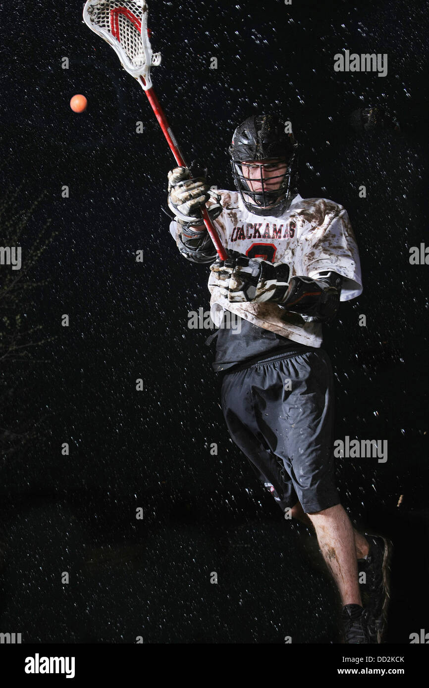 Lacrosse Player Playing In The Rain At Night; Troutdale, Oregon, United