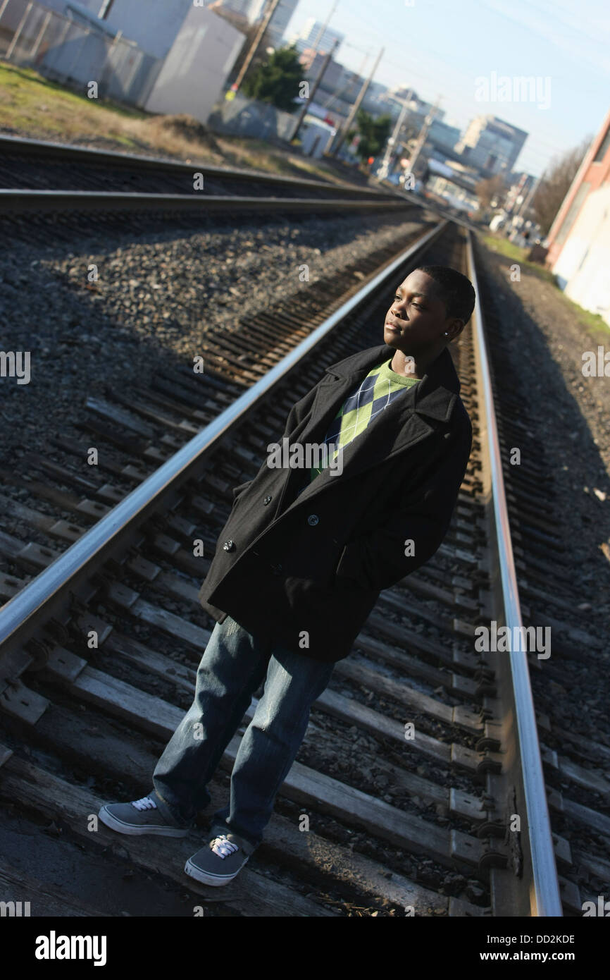 Teenage Boy Standing On Railroad Tracks; Portland, Oregon, United States of America Stock Photo