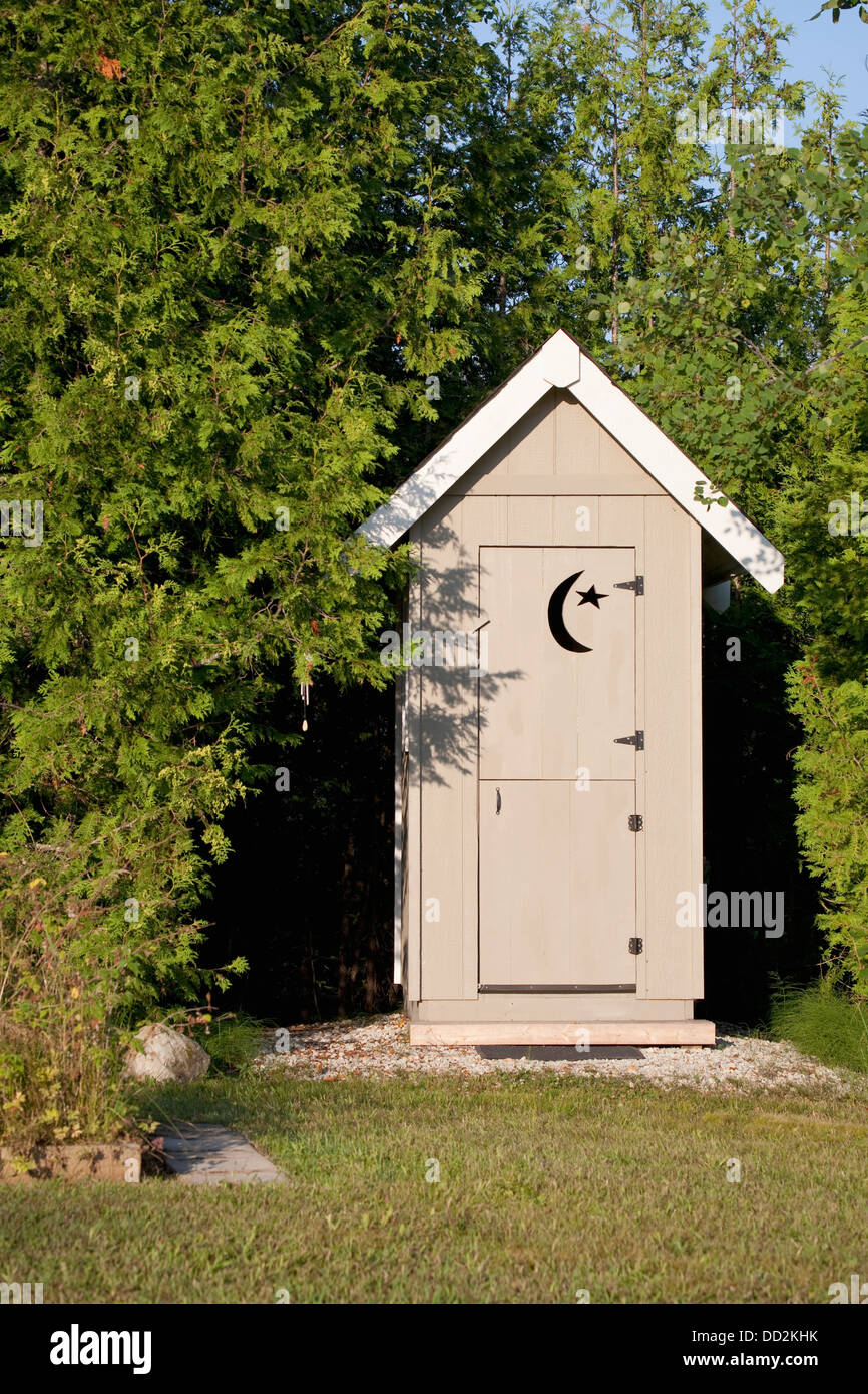 Wooden Outhouse With Crescent Moon And Star Cut Out On Door Stock