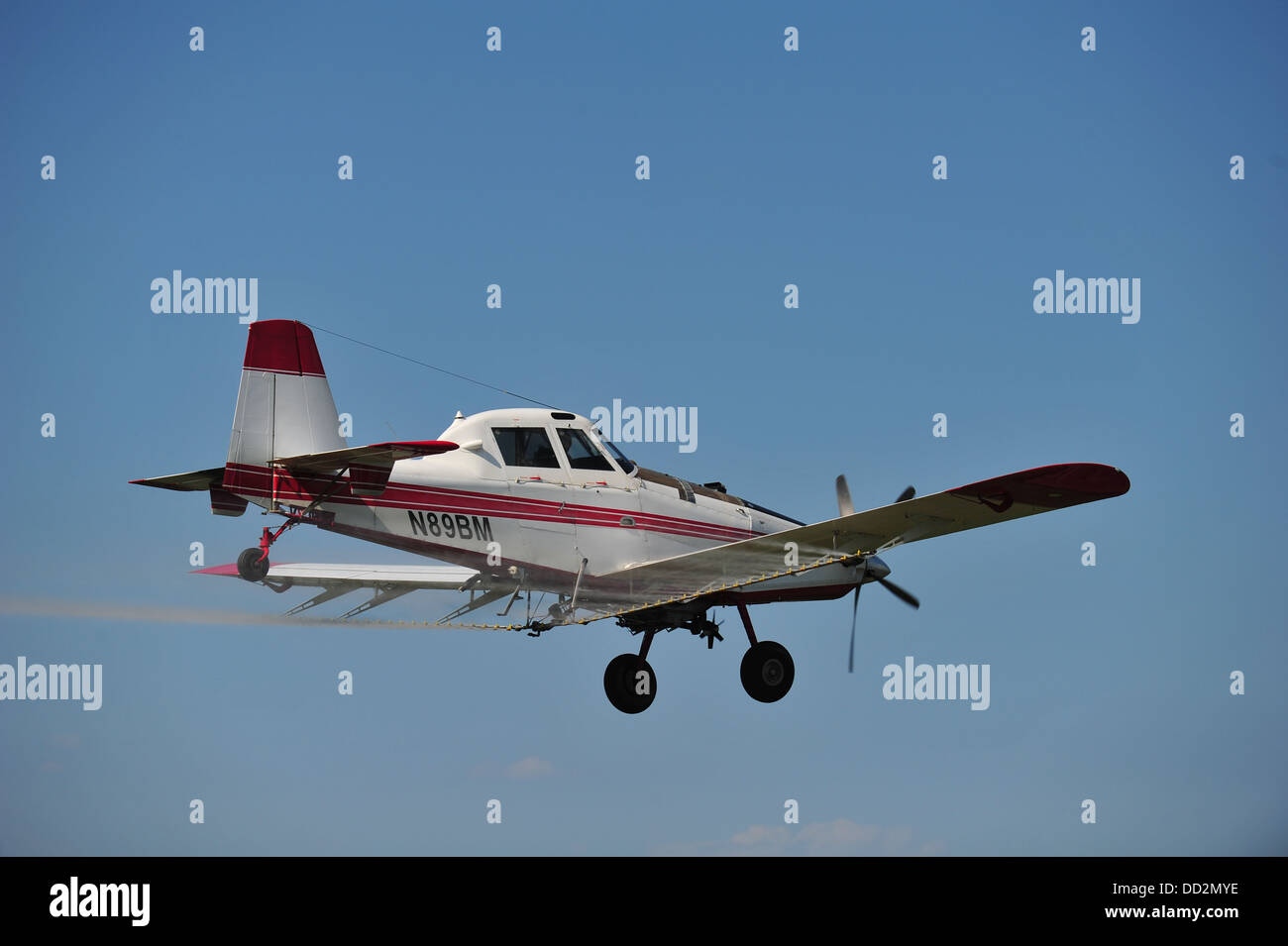 Crop duster spraying soybeans in the summer in rural Indiana, USA Stock Photo