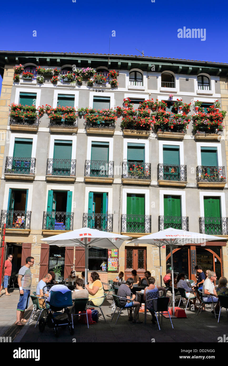 People dine in outside restaurant within the walls of the old quarter in Hondarribia Stock Photo