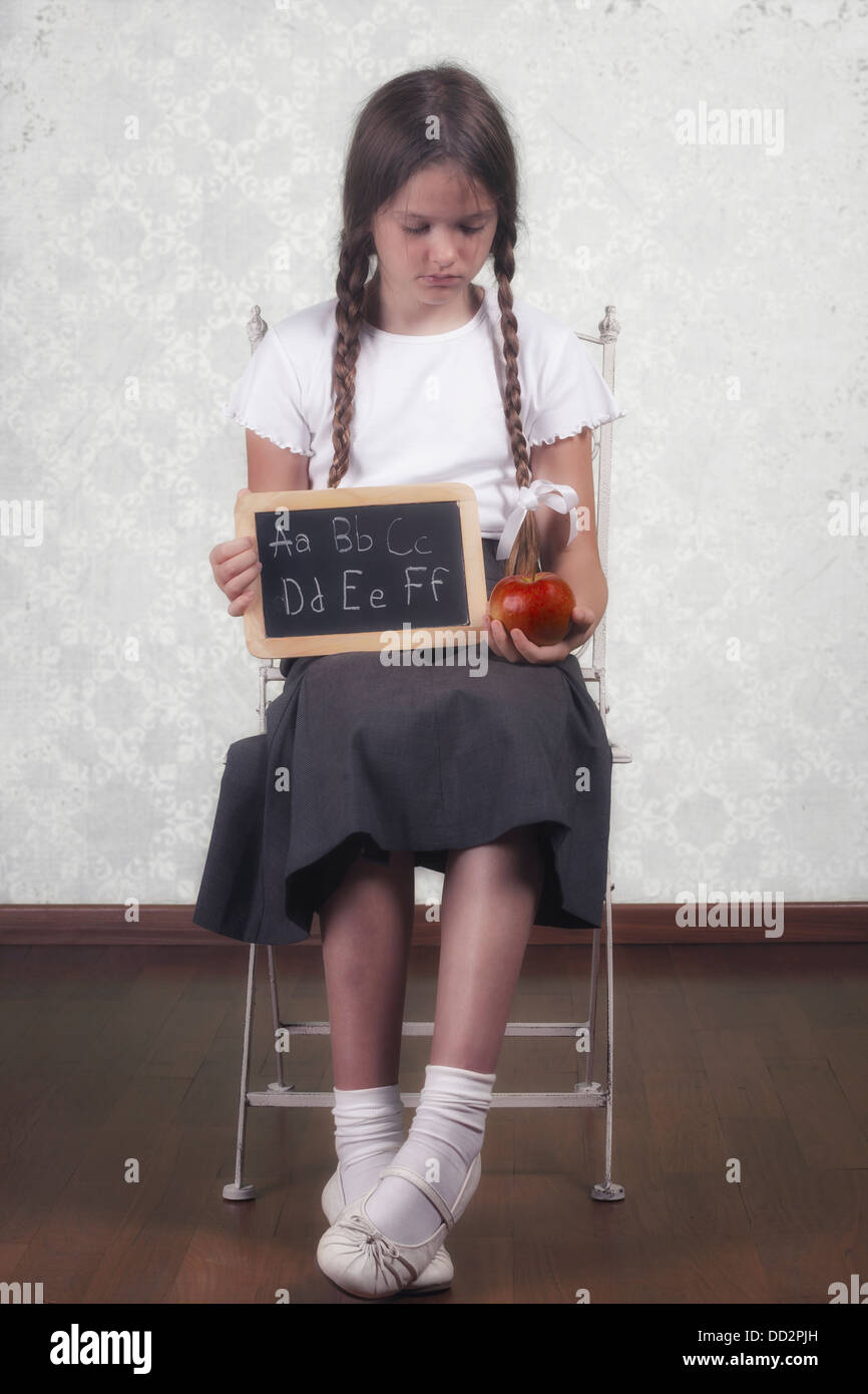 a schoolgirl with an apple and a blackboard Stock Photo