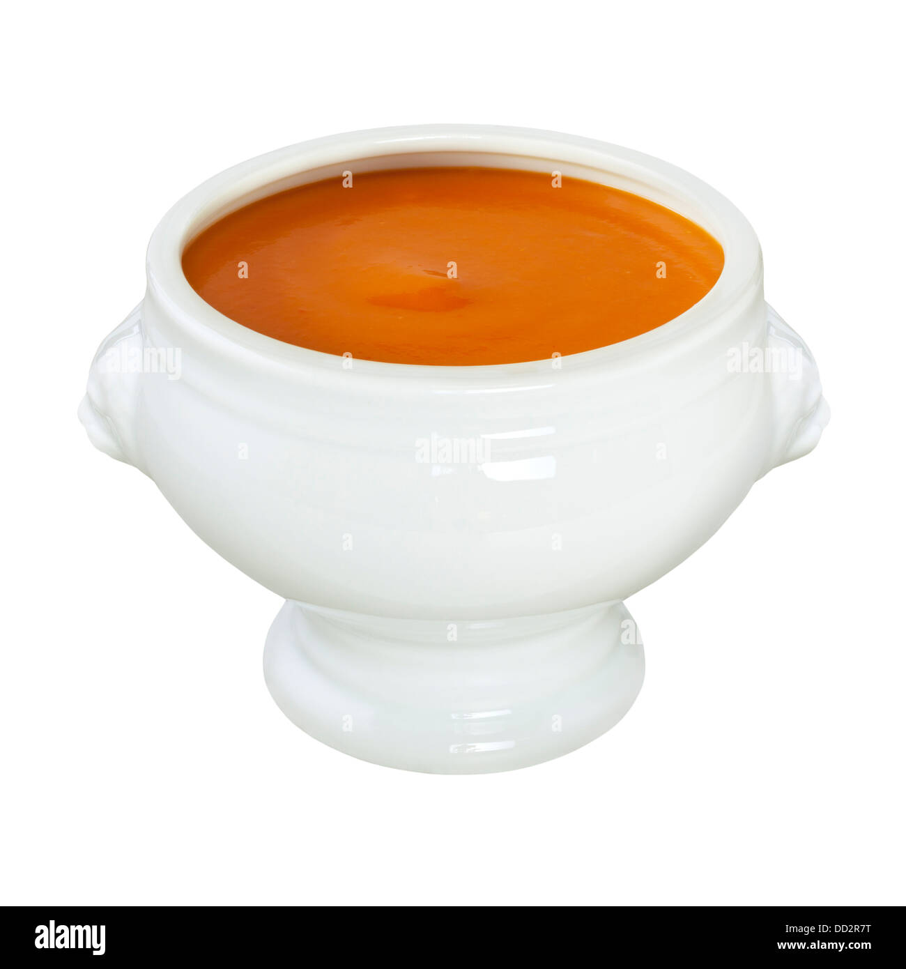 Tomato Soup - a bowl of tomato soup, in a lion head bowl, on a white background, front to back focus and clipping path on bowl. Stock Photo