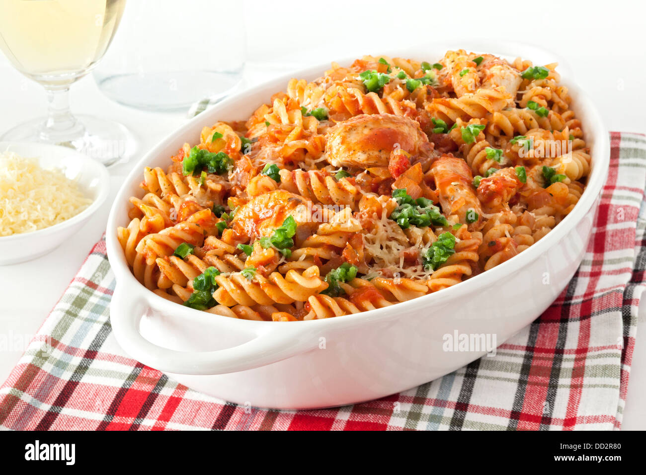 Pasta Bake with Chicken - fusili or spiral pasta, baked with chicken and marinara, topped with green chilli and parmesan. Stock Photo