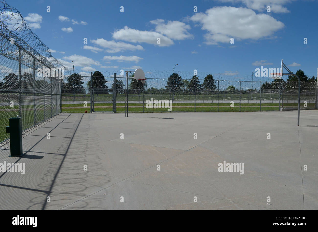 Fenced yard at American maximum security prison. Here inmates are allowed outside to walk, exercise, and socialize. Stock Photo