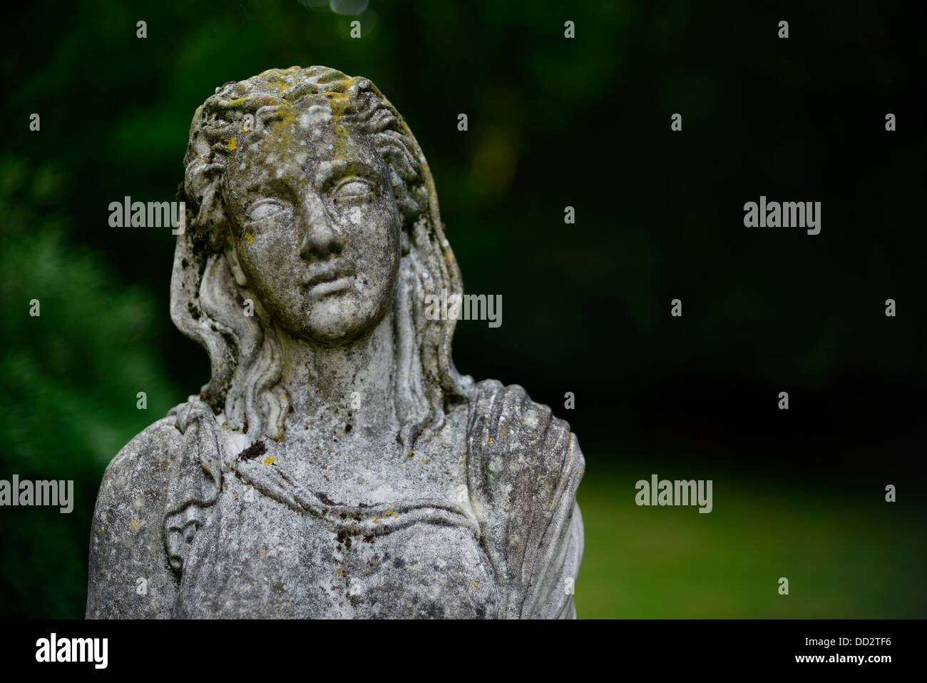 A statue standing in a corner of a stately homes garden Stock Photo