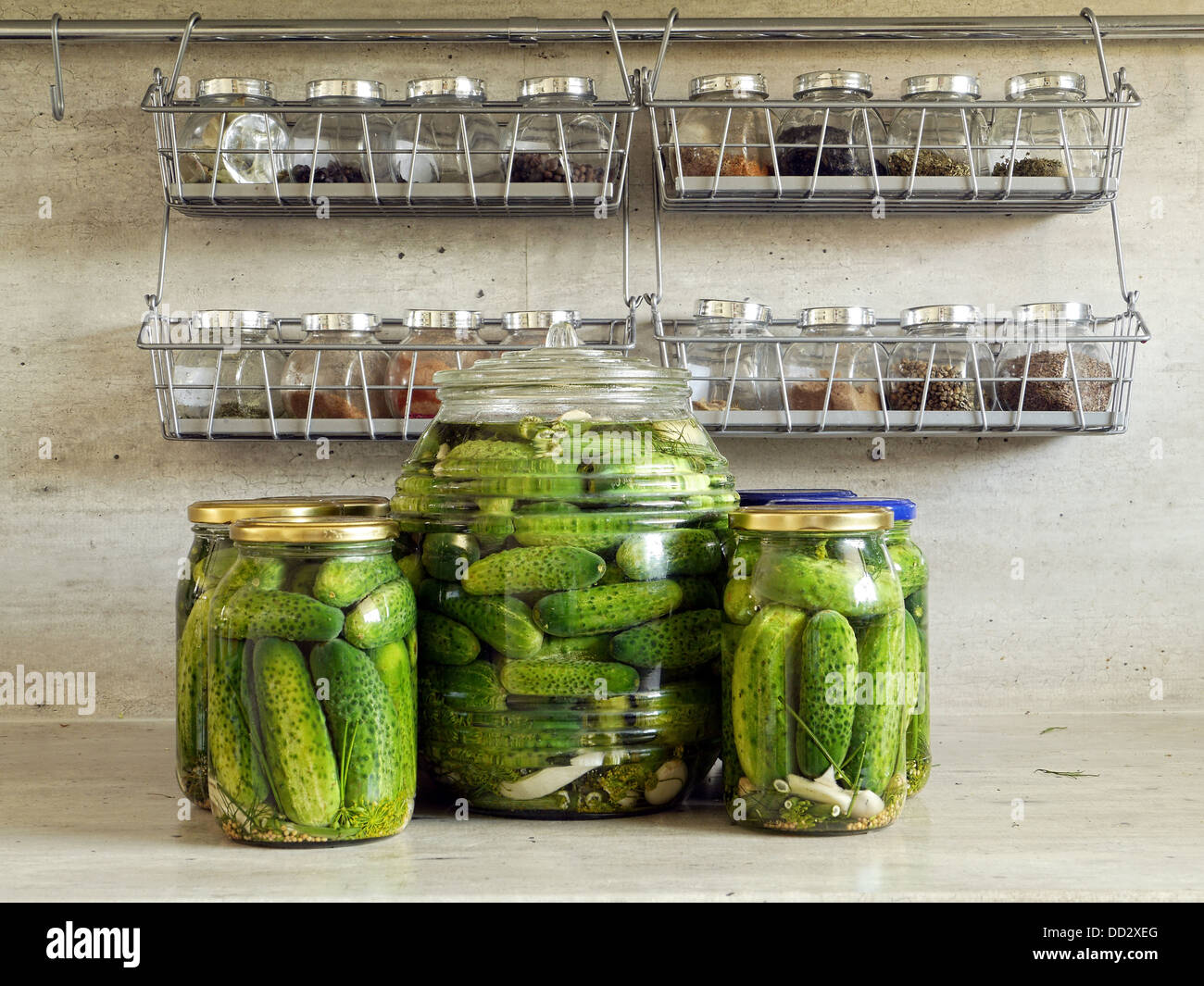 Pickled green cucumbers on kitchen countertop Stock Photo
