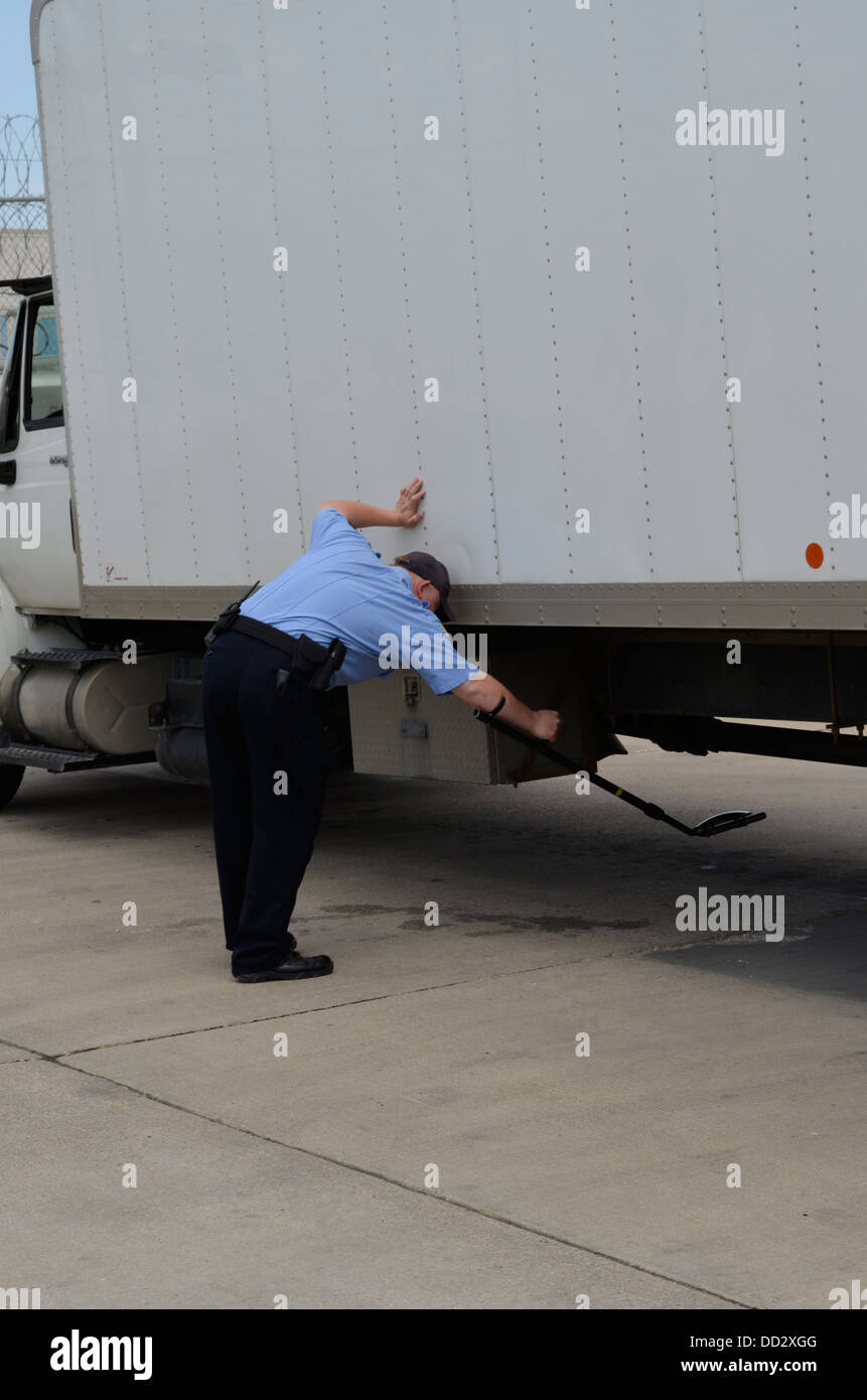 Officer searching vehicle about to enter an American maximum security prison for juvenile offenders. Stock Photo