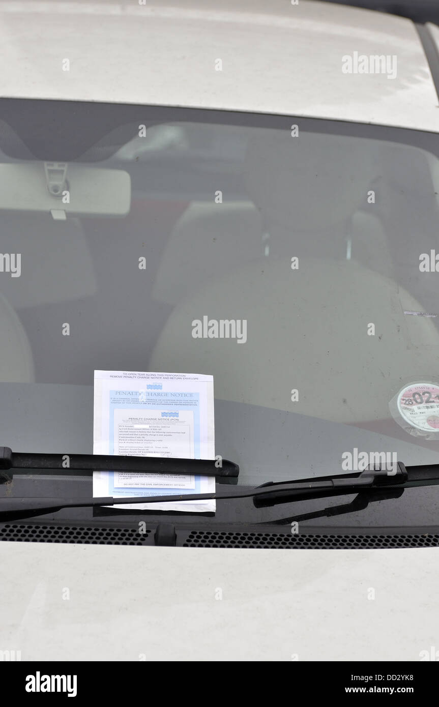 Penalty charge notice PCN under wiper blade on windscreen of car Stock Photo