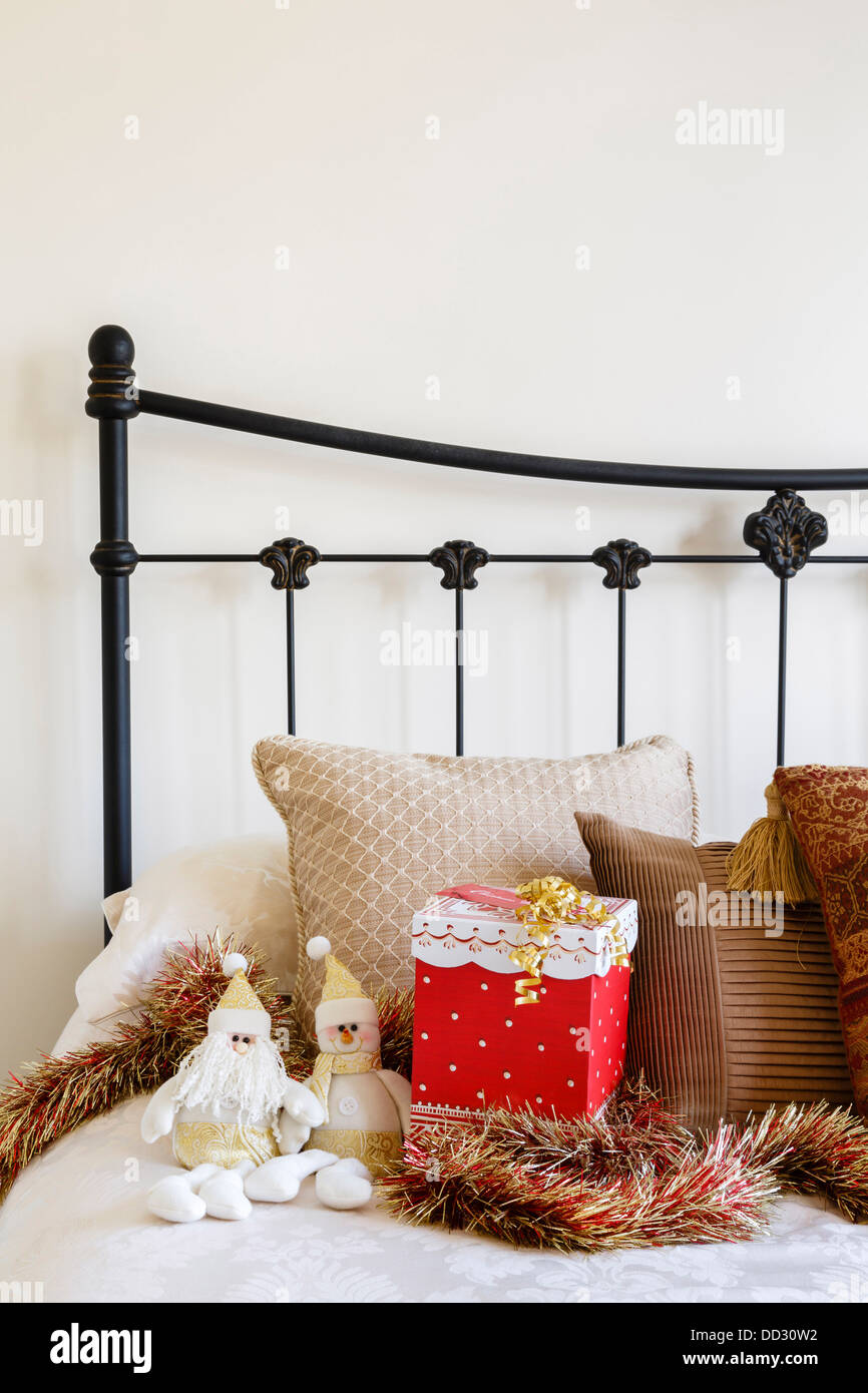 Christmas interior of contemporary bed against a neutral wall Stock Photo
