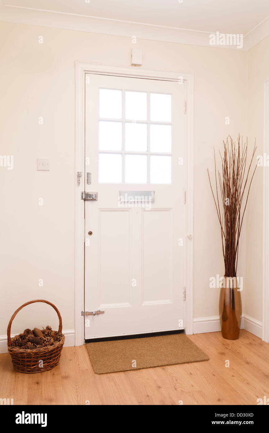 Contemporary hallway in a house with a white front door Stock Photo