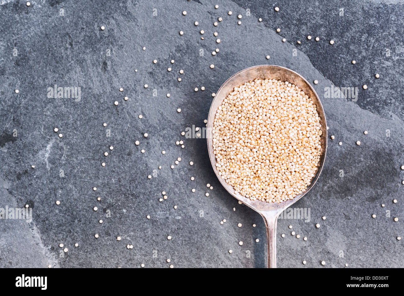 quinoa in a spoon on a slate background Stock Photo