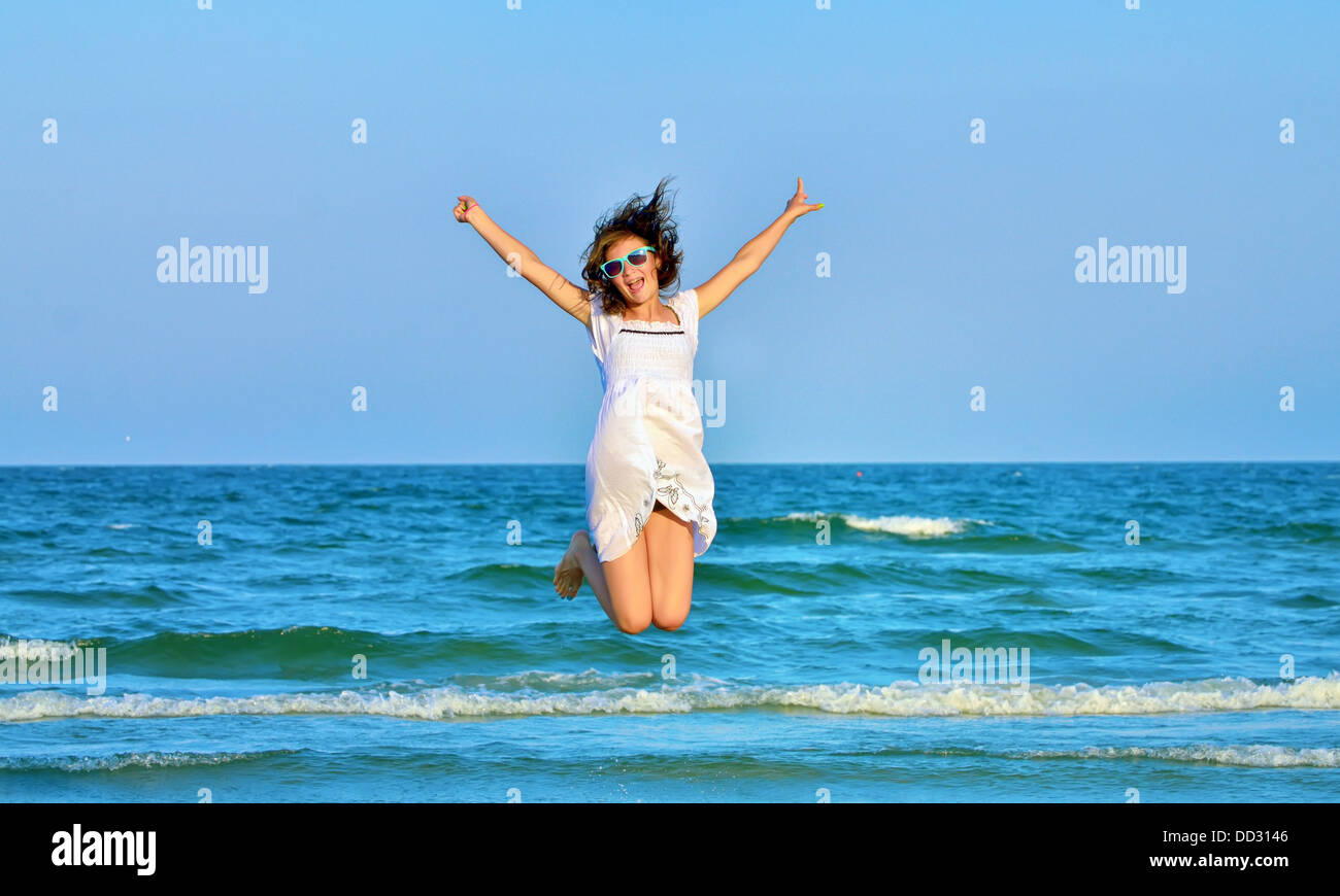 Happy girl jumping blue sky hi-res stock photography and images - Alamy