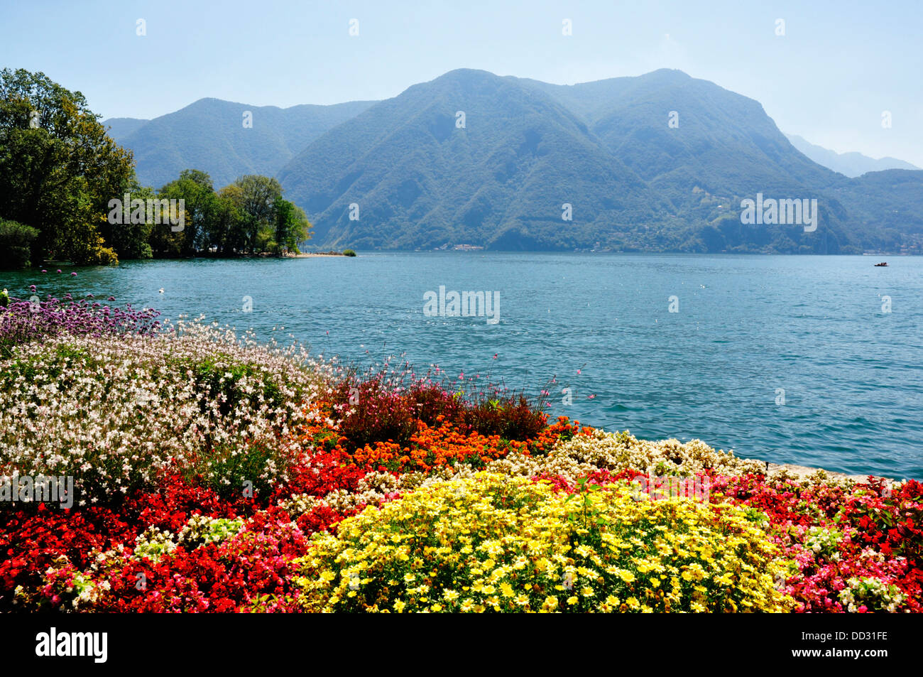 Switzerland - Lake Lugano - colourful flower displays in the Parco Civico - backdrop of the lake and mountains Stock Photo