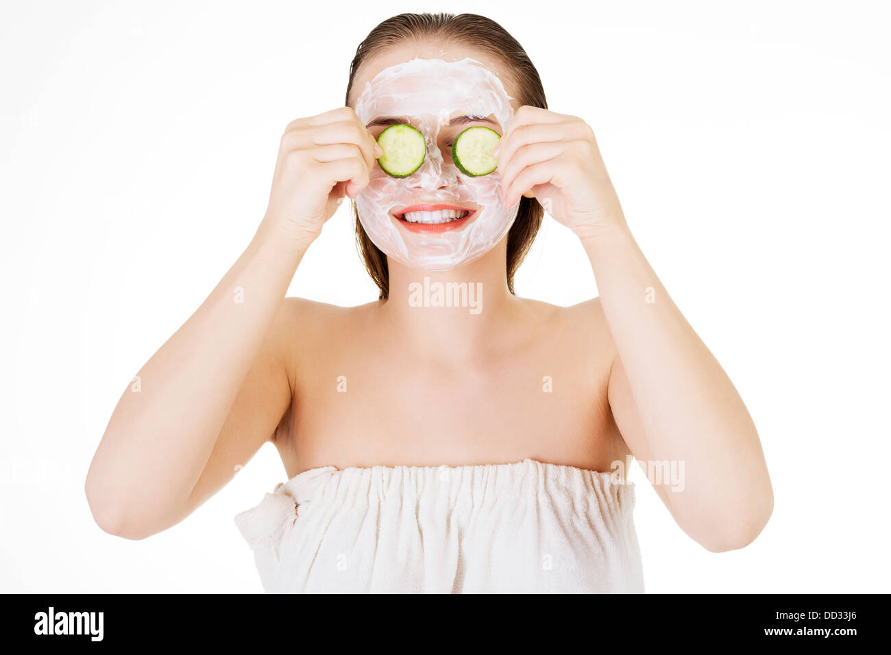 Young woman with cucumber slices in a spa saloon  Stock Photo