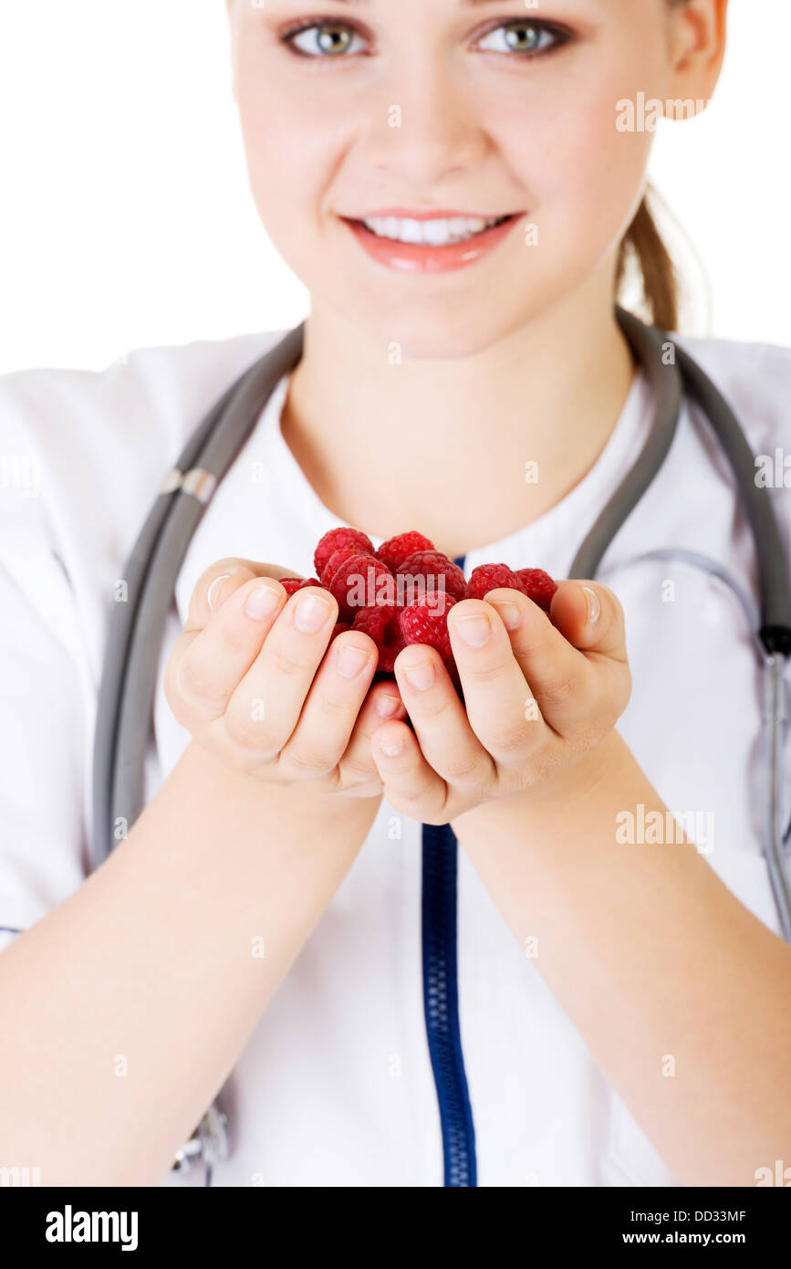 Healthy raspberries. Female doctor holding raspberries in hand. Stock Photo