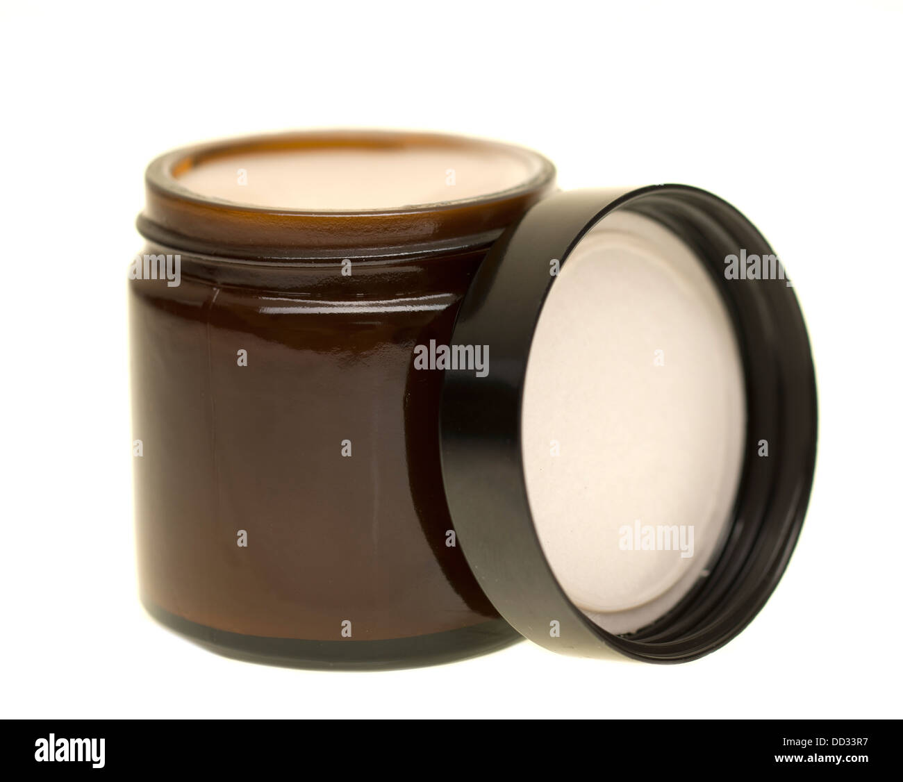 Small brown glass jar and screw cap full of ointment Stock Photo
