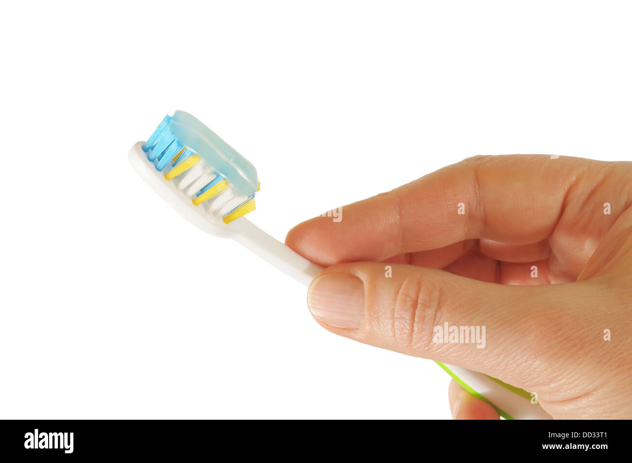 Hand holding a tooth brush with paste isolated on white Stock Photo