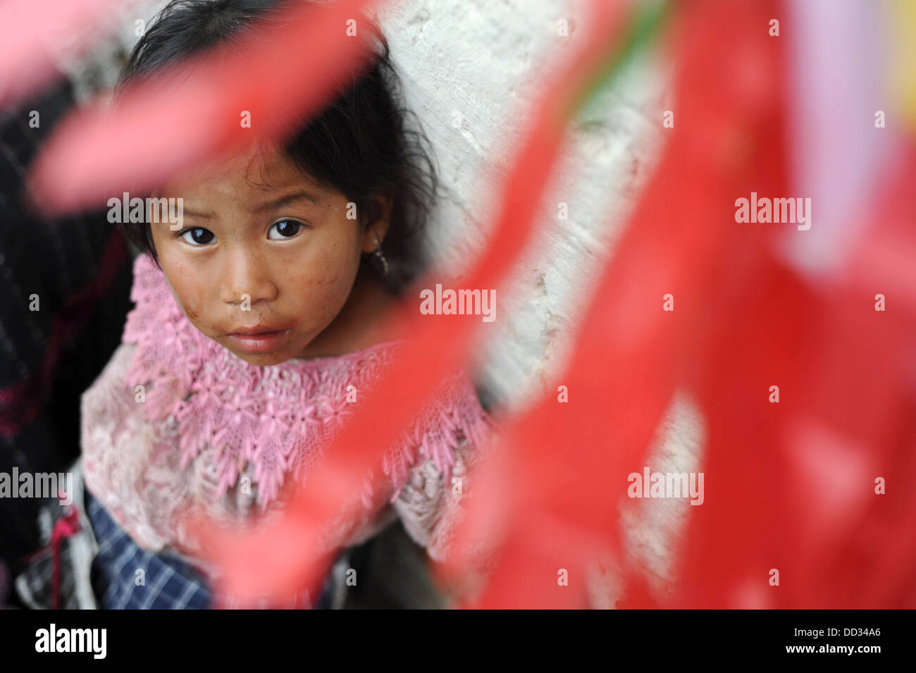 Guatemala indigenous girl in guipil and corte at kite festival on day of the dead in Sumpango, Sacatepeque, Guateamala. Stock Photo