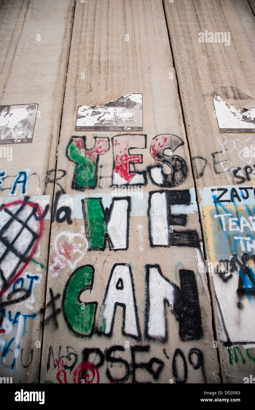 The slogan 'Yes We Can', appears on the Israeli separation wall diving the West Bank town of Bethlehem. Stock Photo