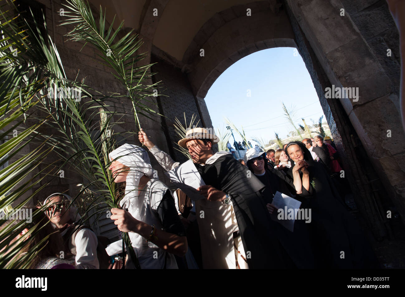 Christian pilgrims enter the Lions' Gate of the Old City of Jerusalem in the annual Palm Sunday procession. Stock Photo