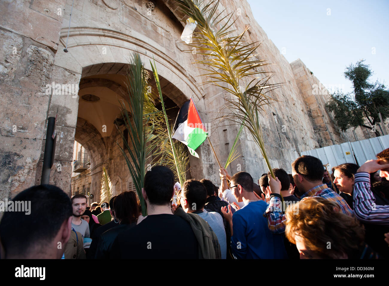 Christian pilgrims enter the Lions' Gate of the Old City of Jerusalem in the annual Palm Sunday procession. Stock Photo
