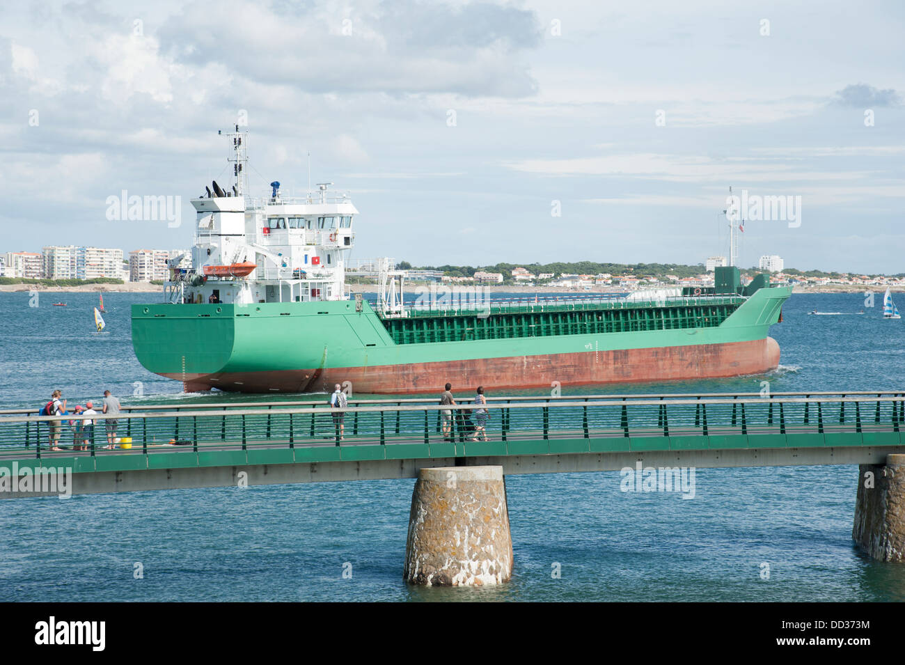 Cargo ship departing port Stock Photo