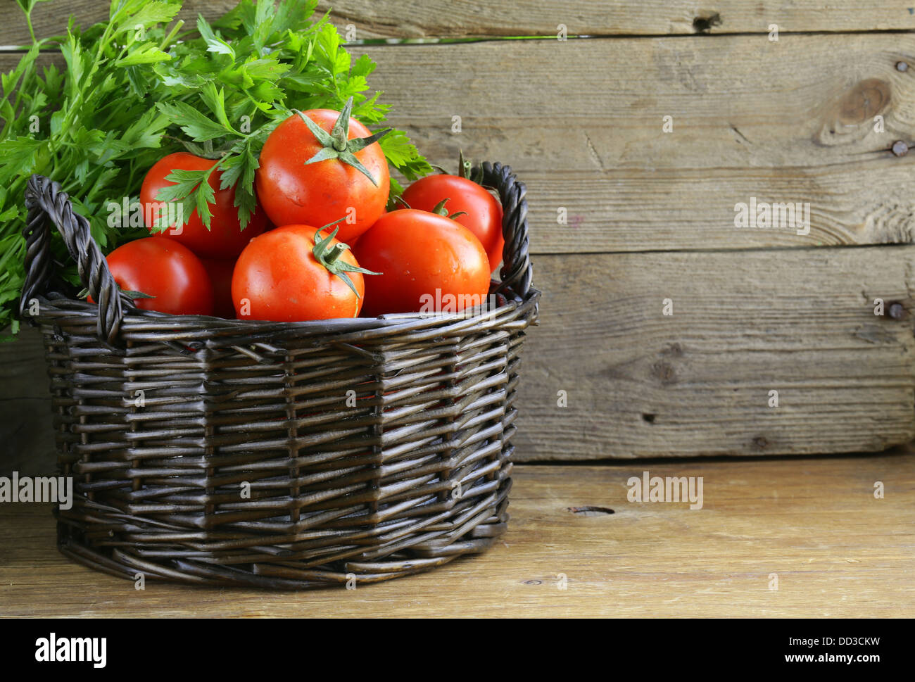 fresh ripe tomatoes in a basket on the table Stock Photo - Alamy