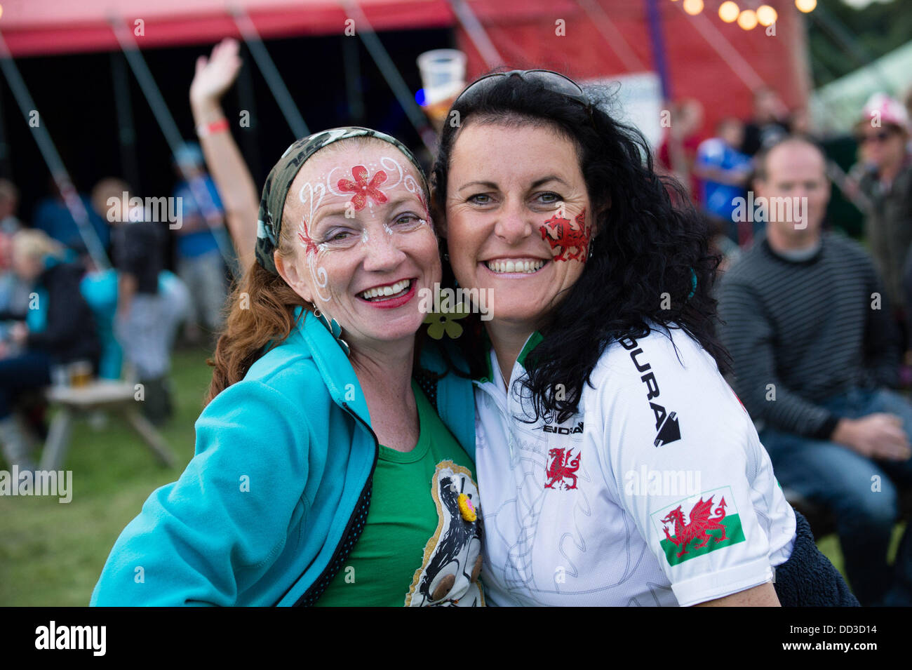 Aberystwyth Wales UK, Saturday 24 August 2013 Two adult women enjoying themselves at a music festival  The second day of the  2013 Big Tribute Festival, Wales's only music festival devoted to covers bands. August Bank Holiday weekend 2013  photo Credit:  keith  morris/Alamy Live News Stock Photo