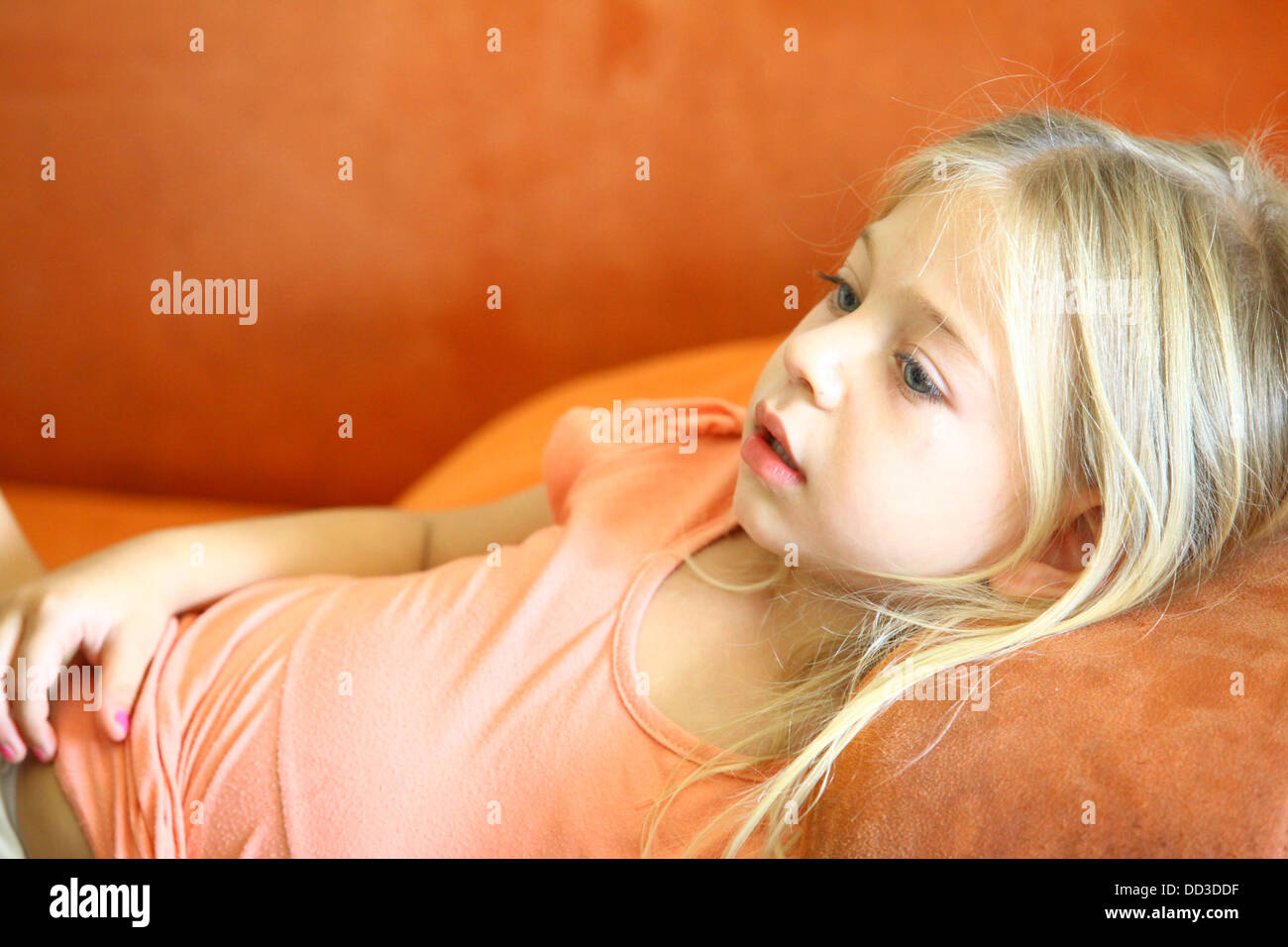 Young girl of 4 engrossed in a TV show Model release available Stock Photo