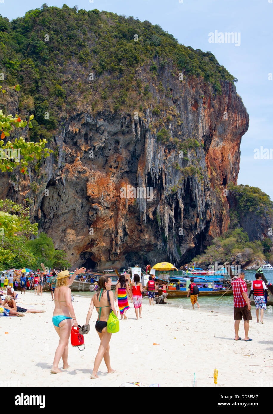 People walk and sunbath on the beach at Hat Phra Nang in Railay. Stock Photo