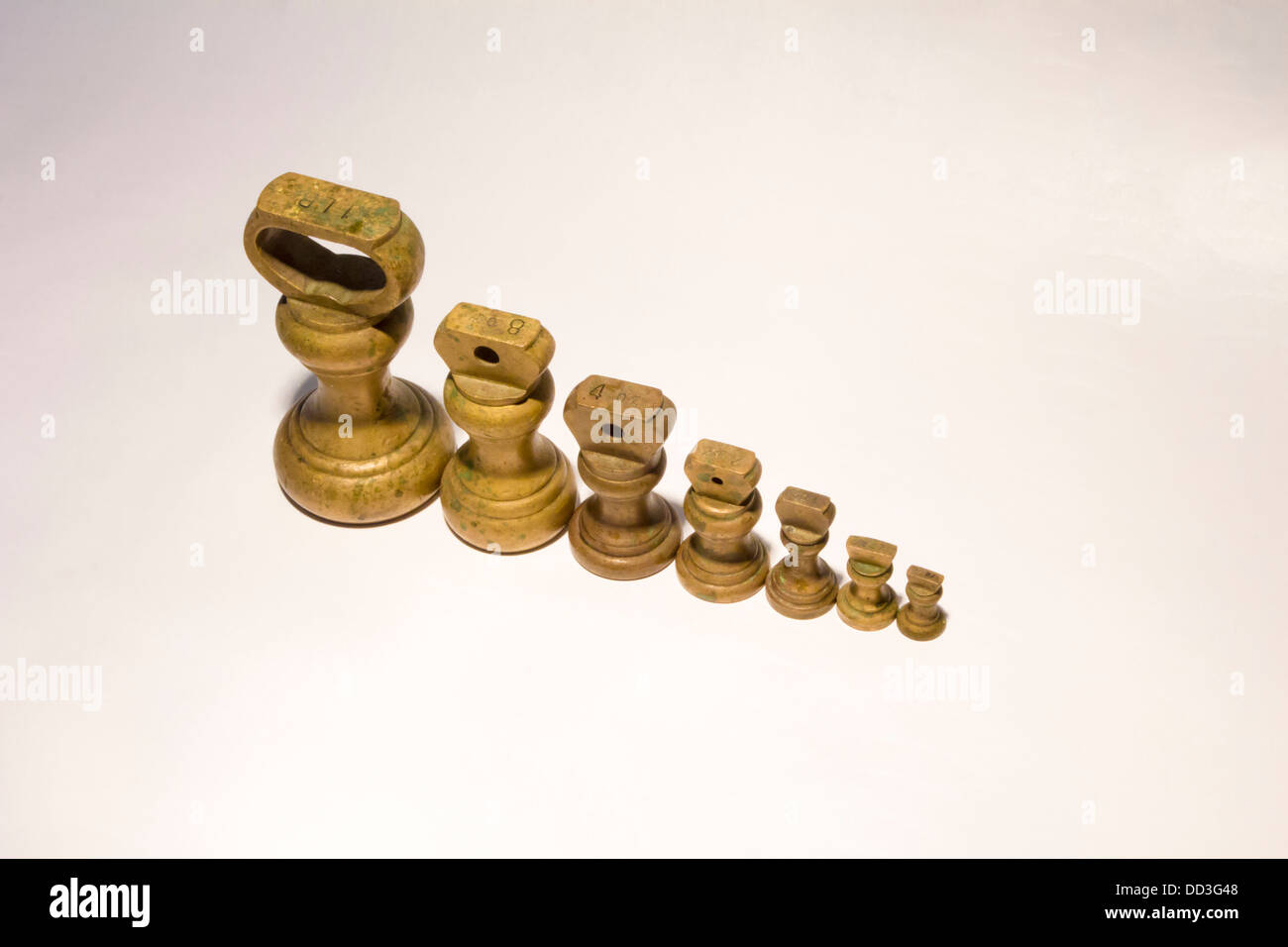 Brass Kitchen weights linedup on white background Stock Photo Alamy
