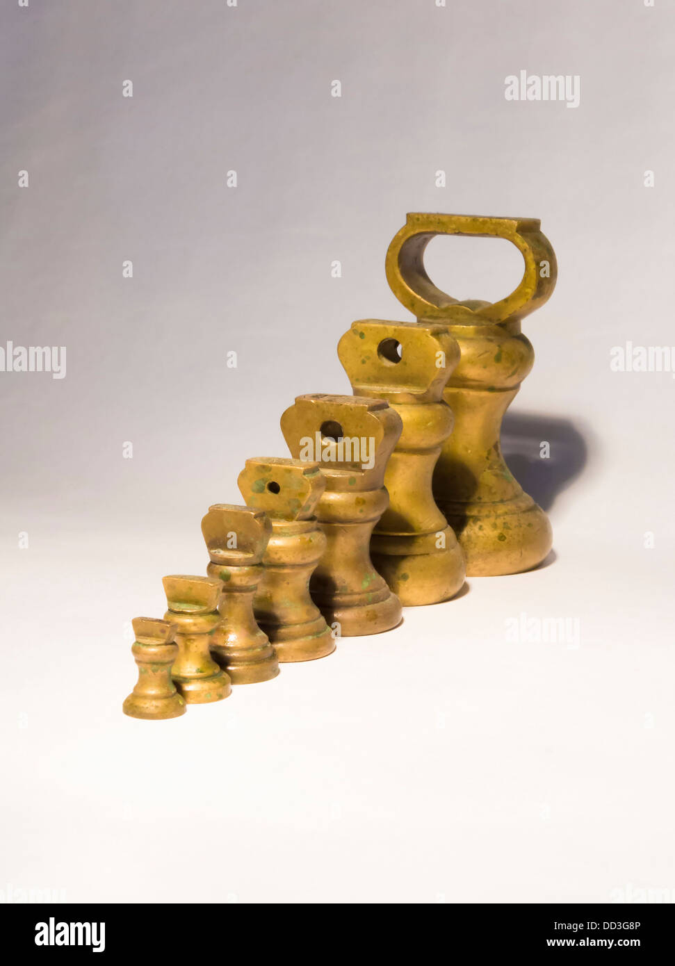 Brass Kitchen weights linedup on white background Stock Photo Alamy
