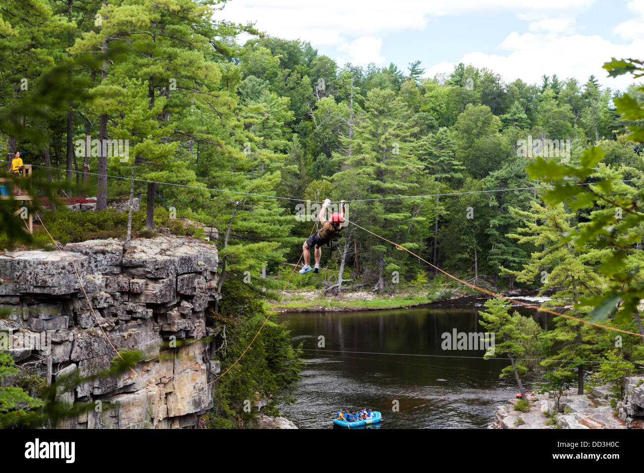 Crossing the river on a climbing rope Stock Photo