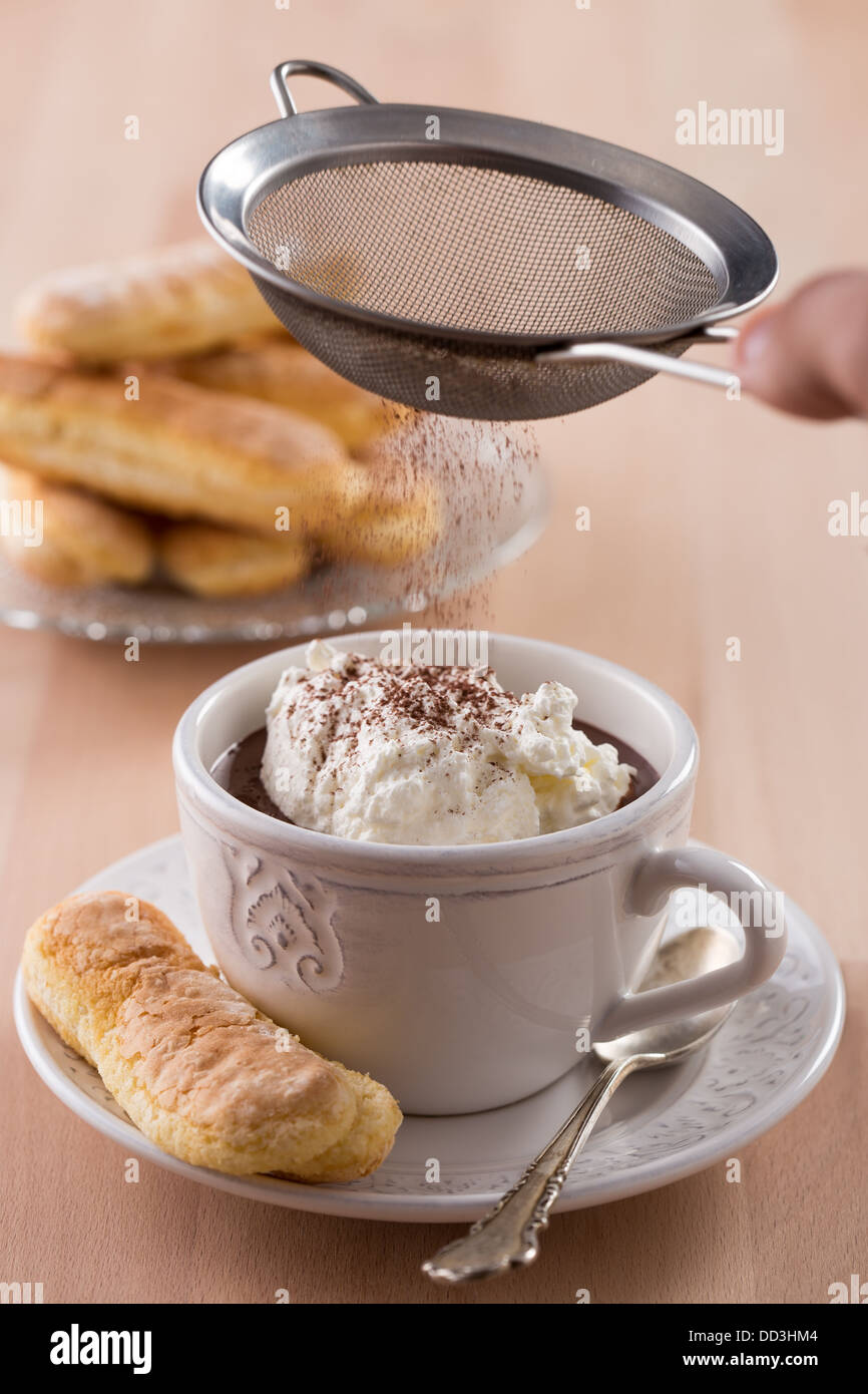 Chocolate cup with whipped cream and ladyfingers on wooden table Stock Photo