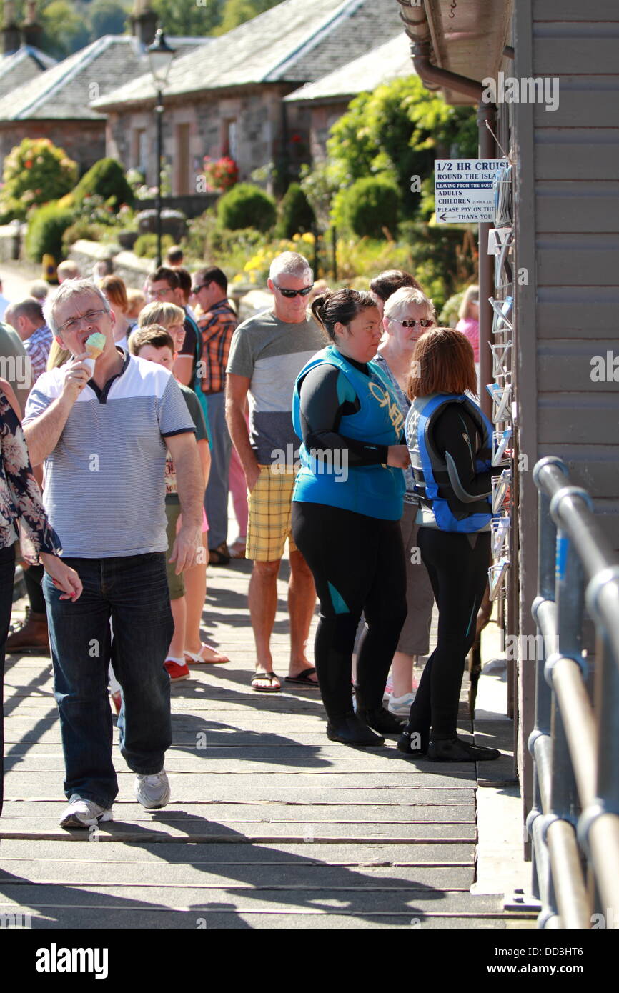 A large queue for Ice Cream at a shop in Luss, Loch Lomond, Scotland, UK Stock Photo