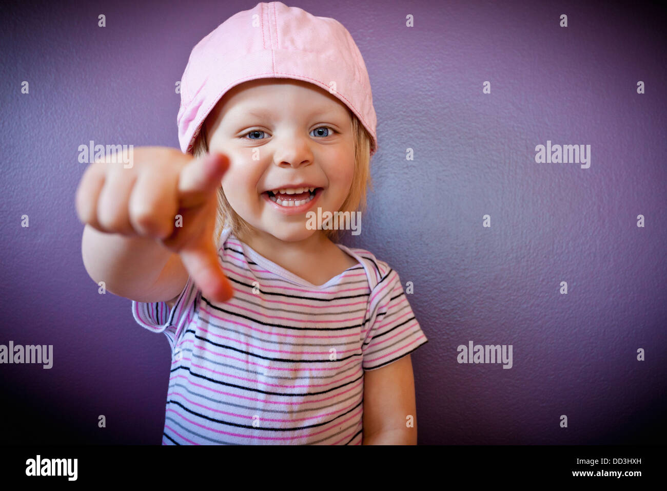 A Young Girl Points At The Camera; Spruce Grove, Alberta, Canada Stock