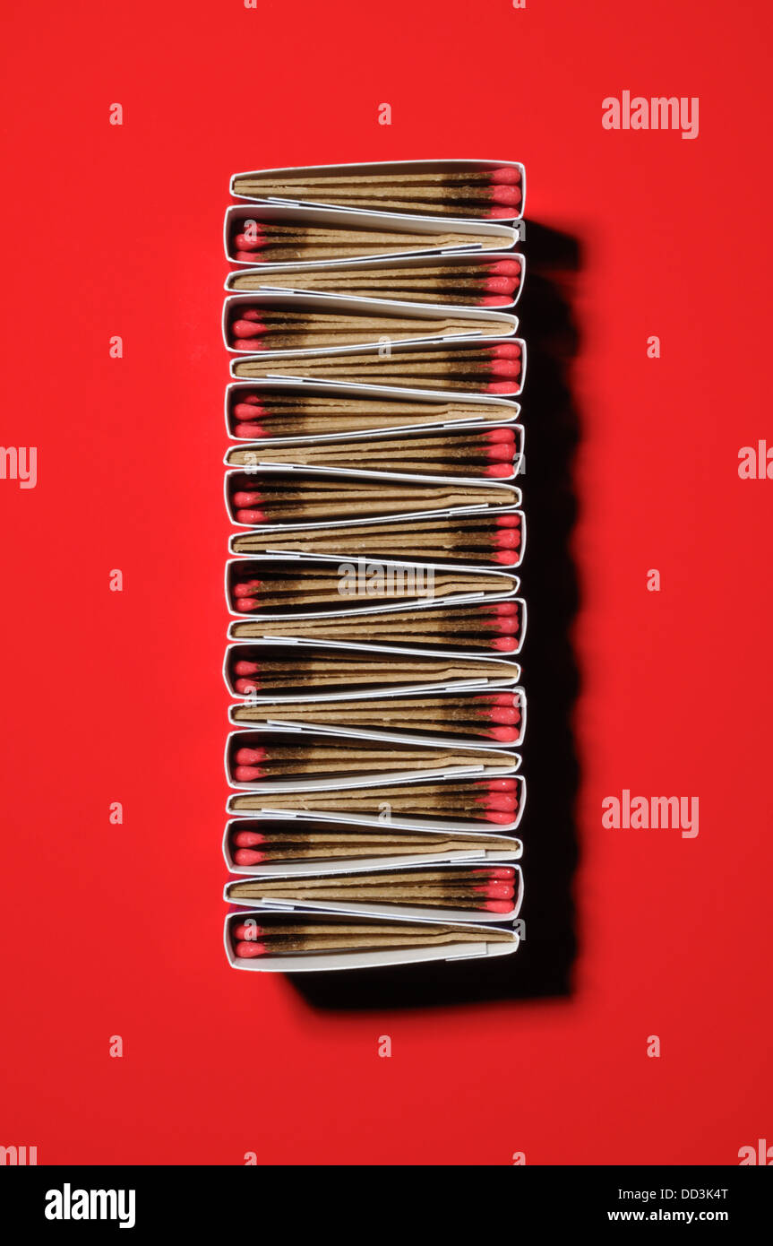 Packs of matches together forming a unique pattern. Long rectangular shape, red background Stock Photo