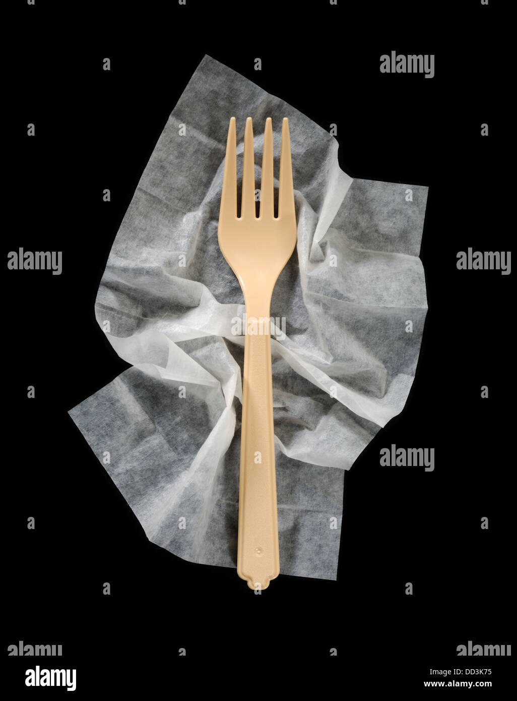 A plastic dinner fork on a crumpled cleaning napkin. Stock Photo