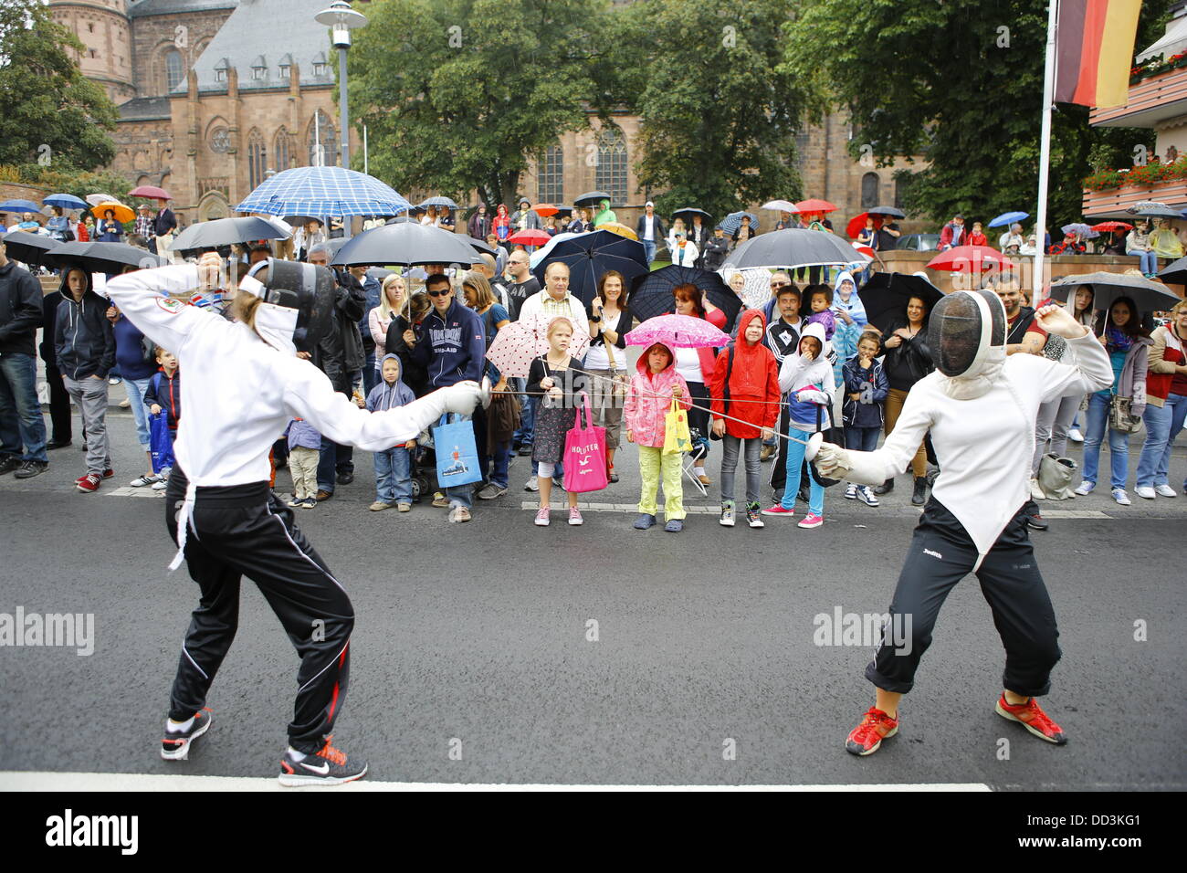 Worms, Germany. 25th August 2013. Two fencer fence outside the Cathedral of Worms during the Backfischfest parade 2013. The first highlight of this year's Backfischfest was the big parade through the city of Worms with over 100 groups and floats. Community groups, sport clubs, music groups and business from Worms and further afield took part. Credit:  Michael Debets/Alamy Live News Stock Photo