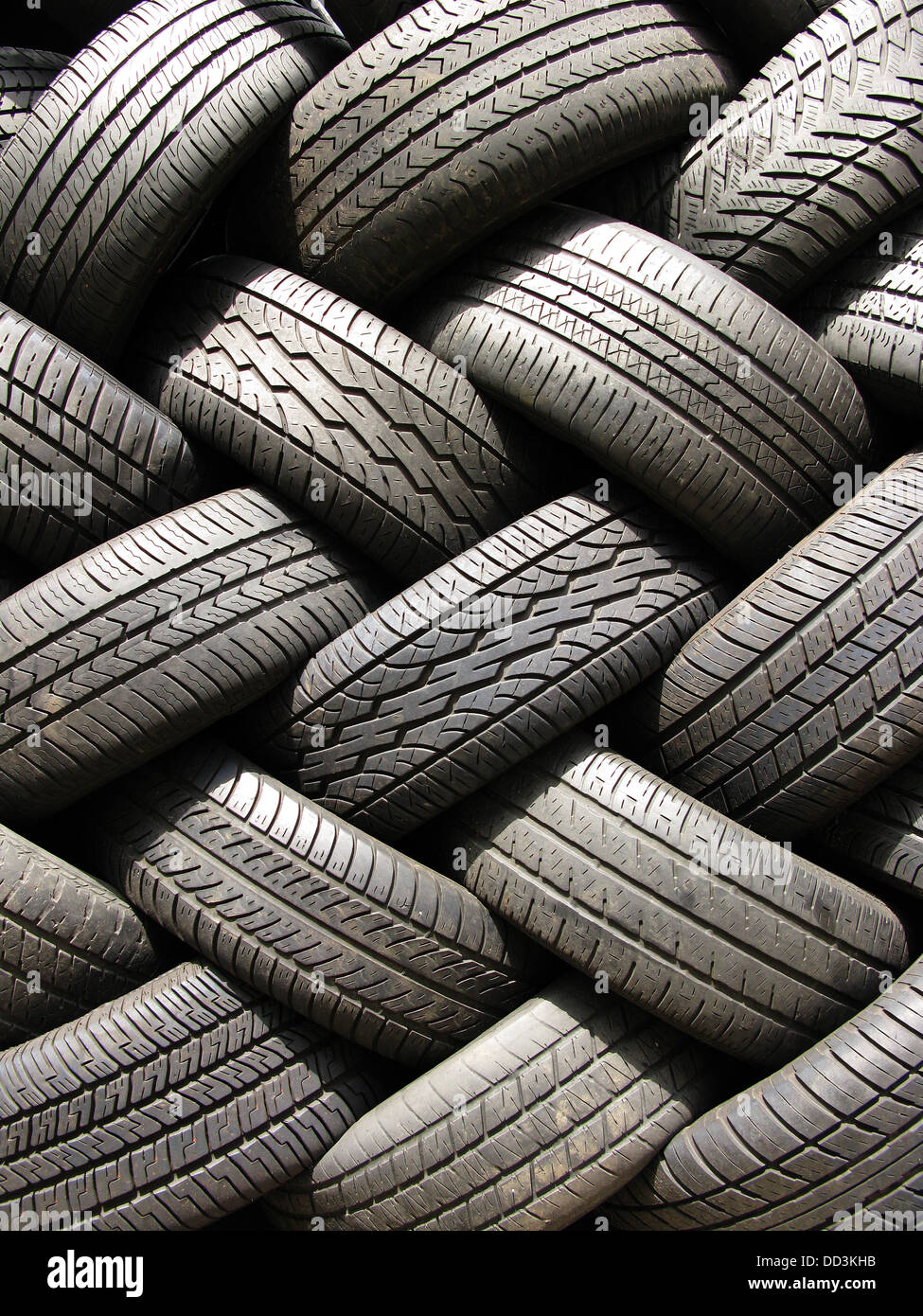 A large stack of used automotive car tires. Stock Photo