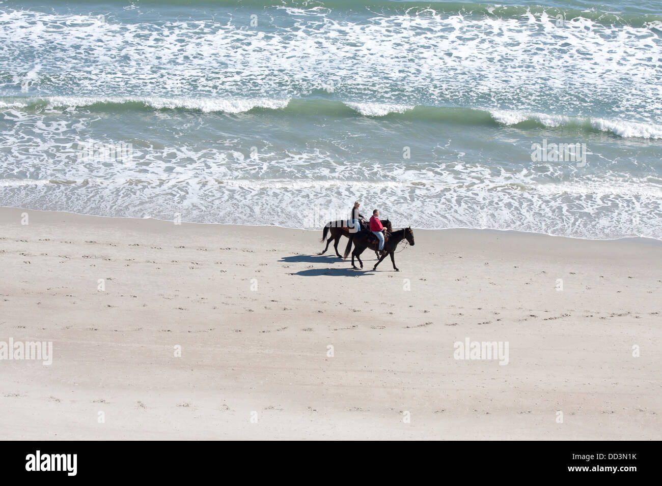 Couple Riding Horses On The Beach Stock Photo Alamy