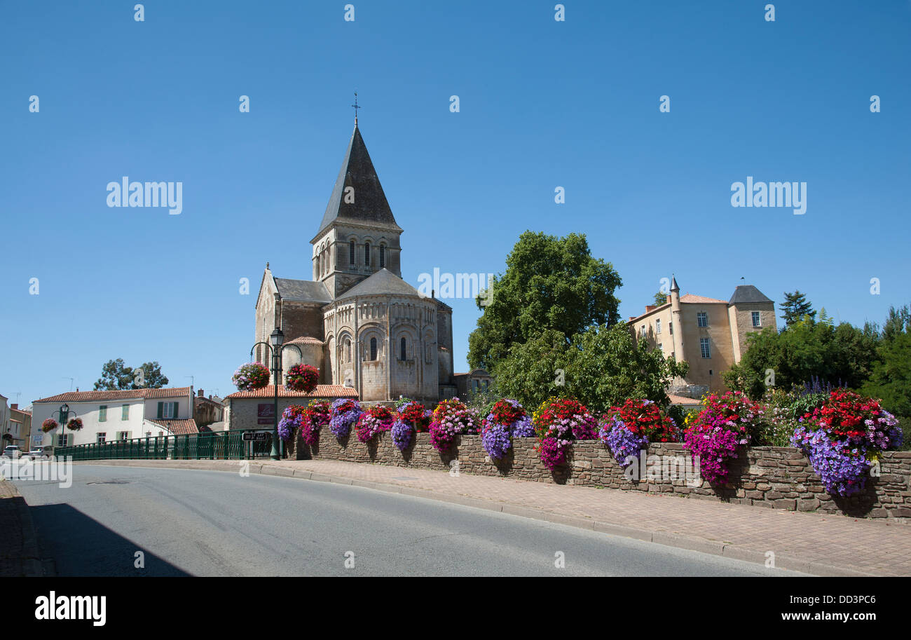 Flowers decorating the roadside at Mareuil sur Lay in the Vendee region of France and the Romanesque church of St Sauveur VII c Stock Photo
